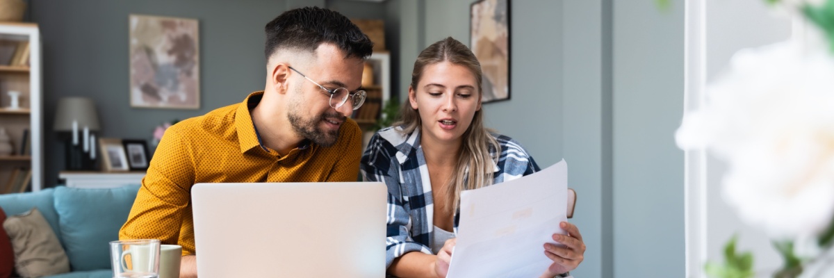 Two young people, couple in relationship, working together at home office