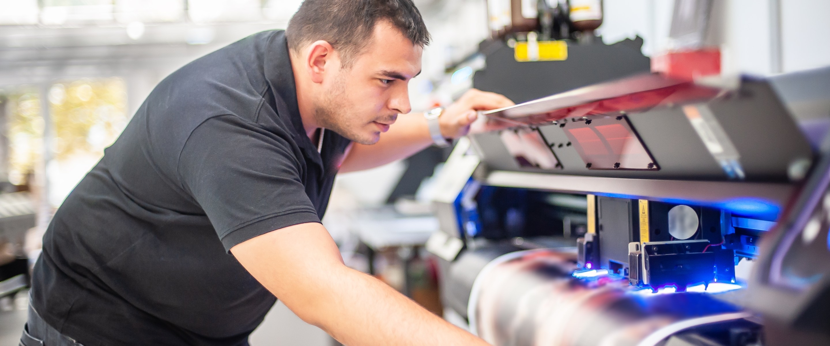 Man using printing machinery.