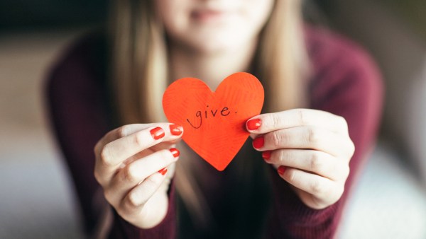 Girl holding giving heart