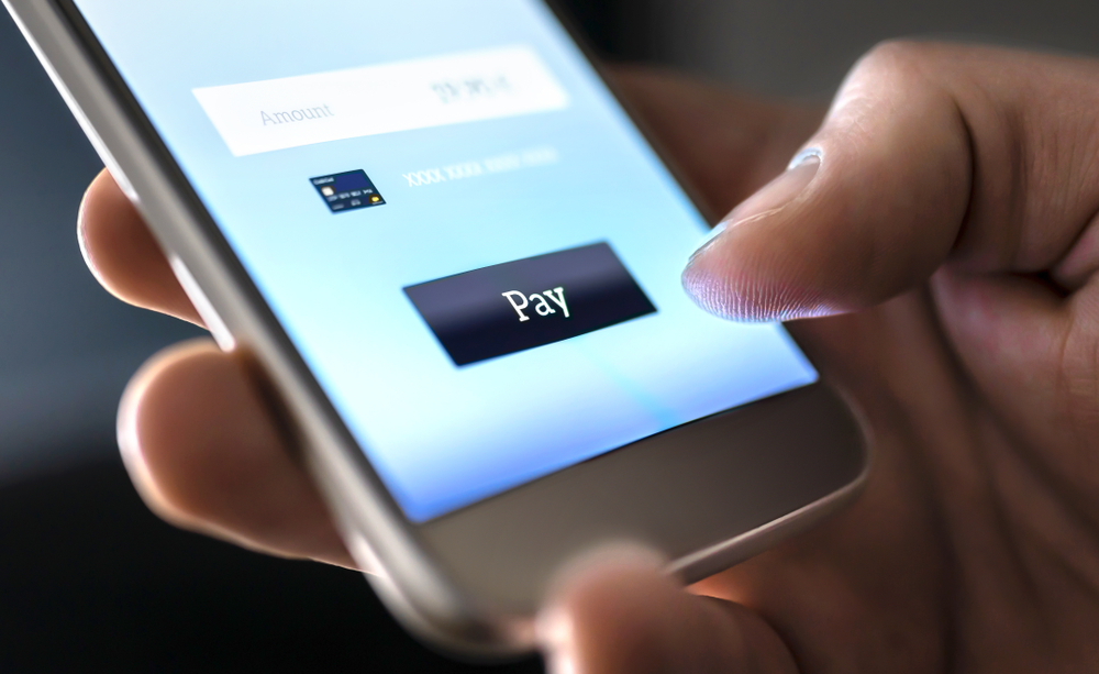 Close-up of someone making a payment on their phone