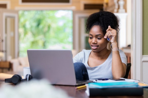 Woman holding glasses on computer