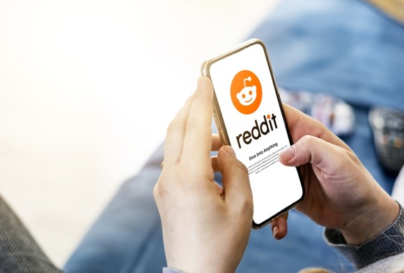 Man opening Reddit app.