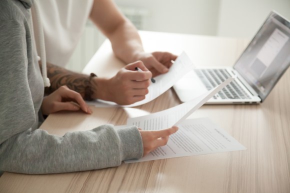 Couple reviewing paperwork together.