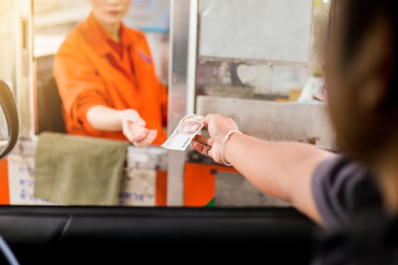 Driver paying toll.