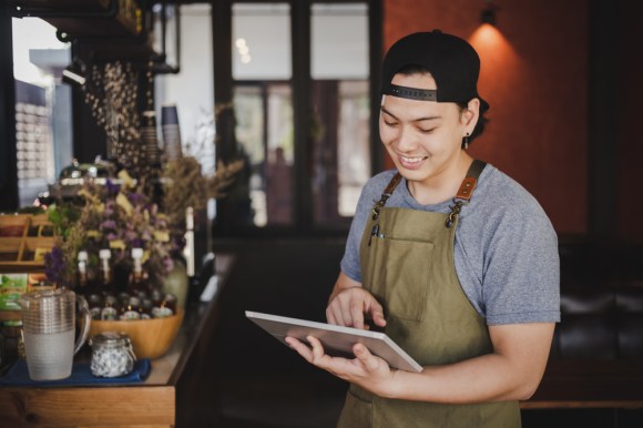 Teen boy working as a barista.