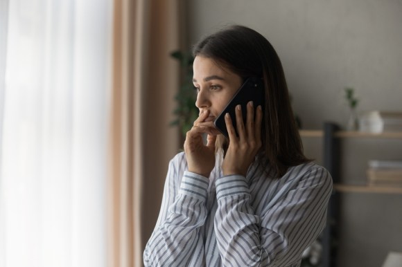 Woman holding a phone to her ear.