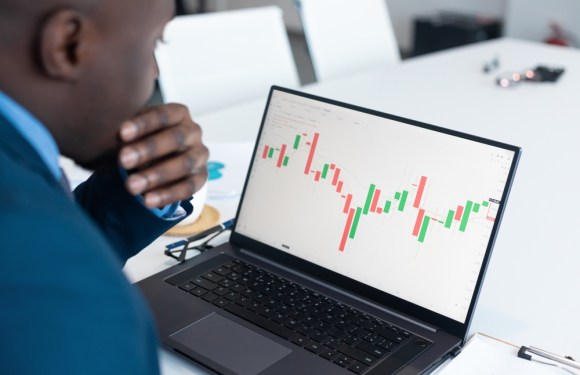 Young Black man looking at stock performance.