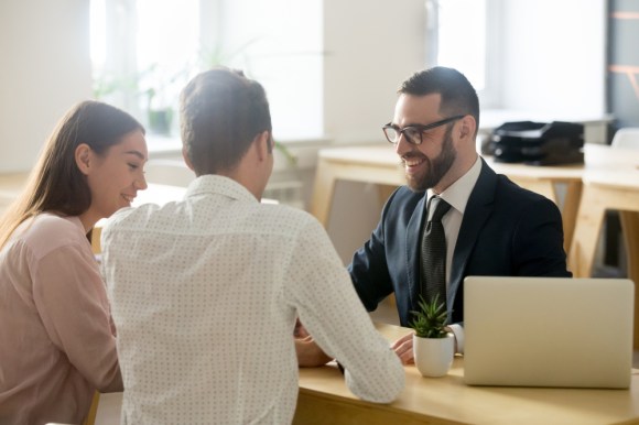 Couple speaking with a financial advisor.