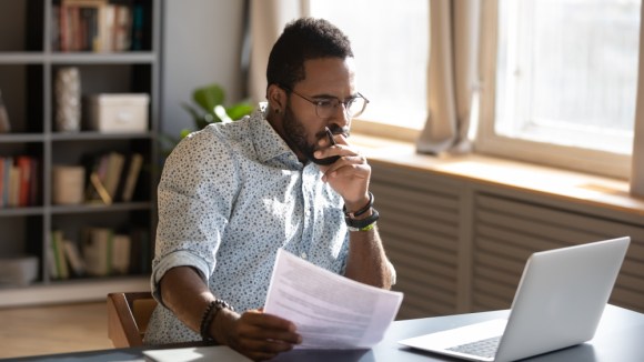 Young Black man considering a decision.