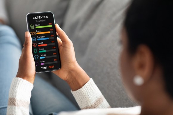 Woman tracking her expenses on her phone.