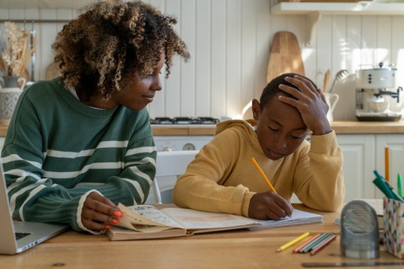 Young woman tutoring a boy.