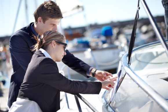 Yacht employees looking at document.