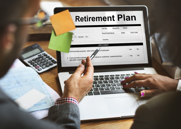 Man helping a woman sign up for a retirement plan.
