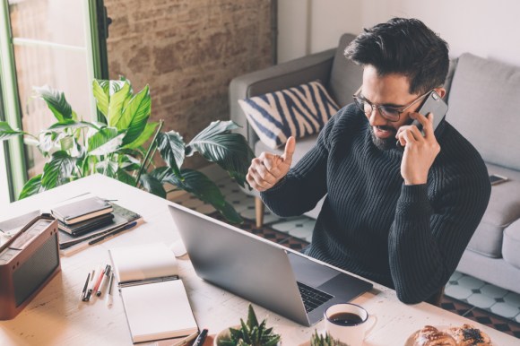 Young man working in a modern home office.
