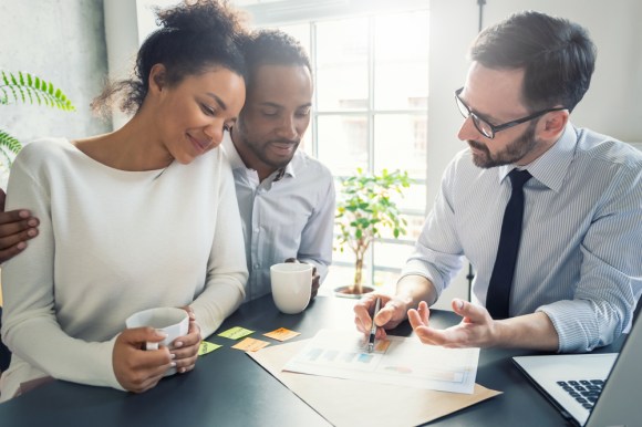 Couple reviewing a document with a lawyer