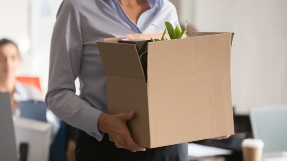  Businesswoman carrying a box of her belongings.