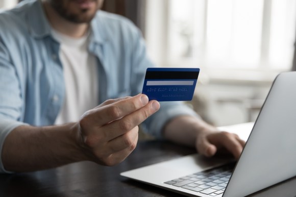 Man making payment online with credit card.
