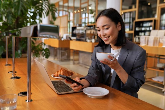 Woman enjoying breakfast at a cafe while working.