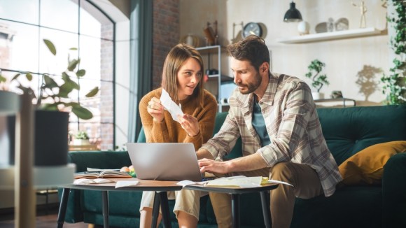 Couple reviewing finances and doing financial planning.
