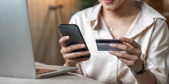 Woman making a credit card payment.