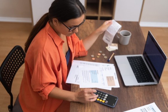 Young business owner reviewing expenses.
