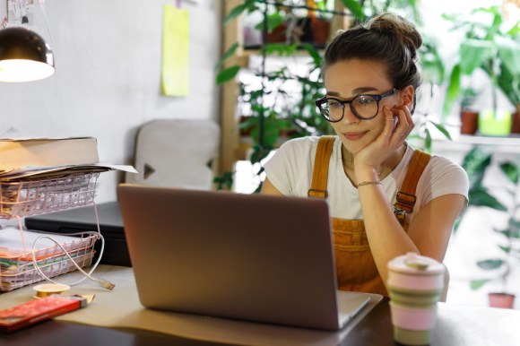 Young women working in home office.
