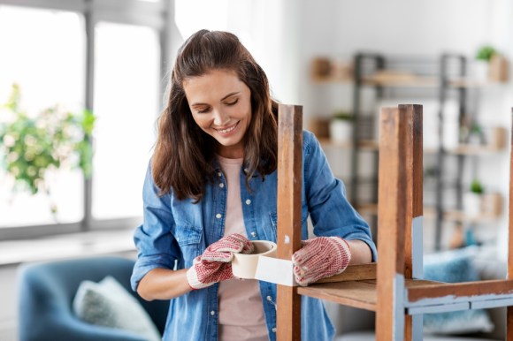 Woman restoring chair.