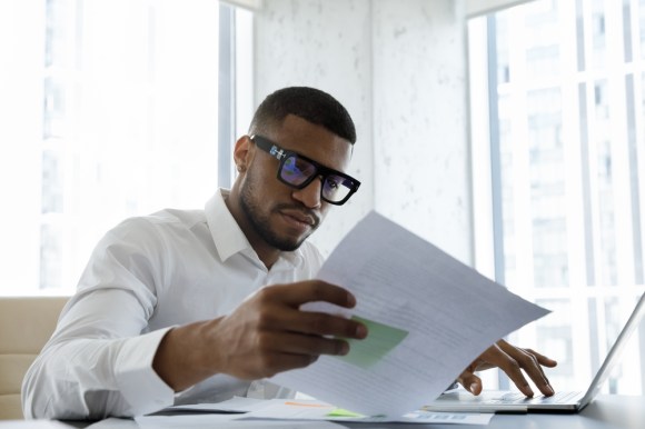 Young Black business man reviewing documents.